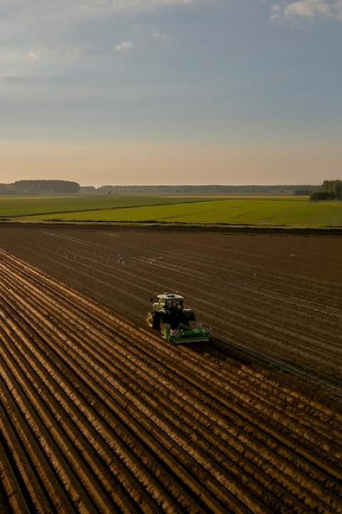 A tractor plowing a farm field — Central Valley